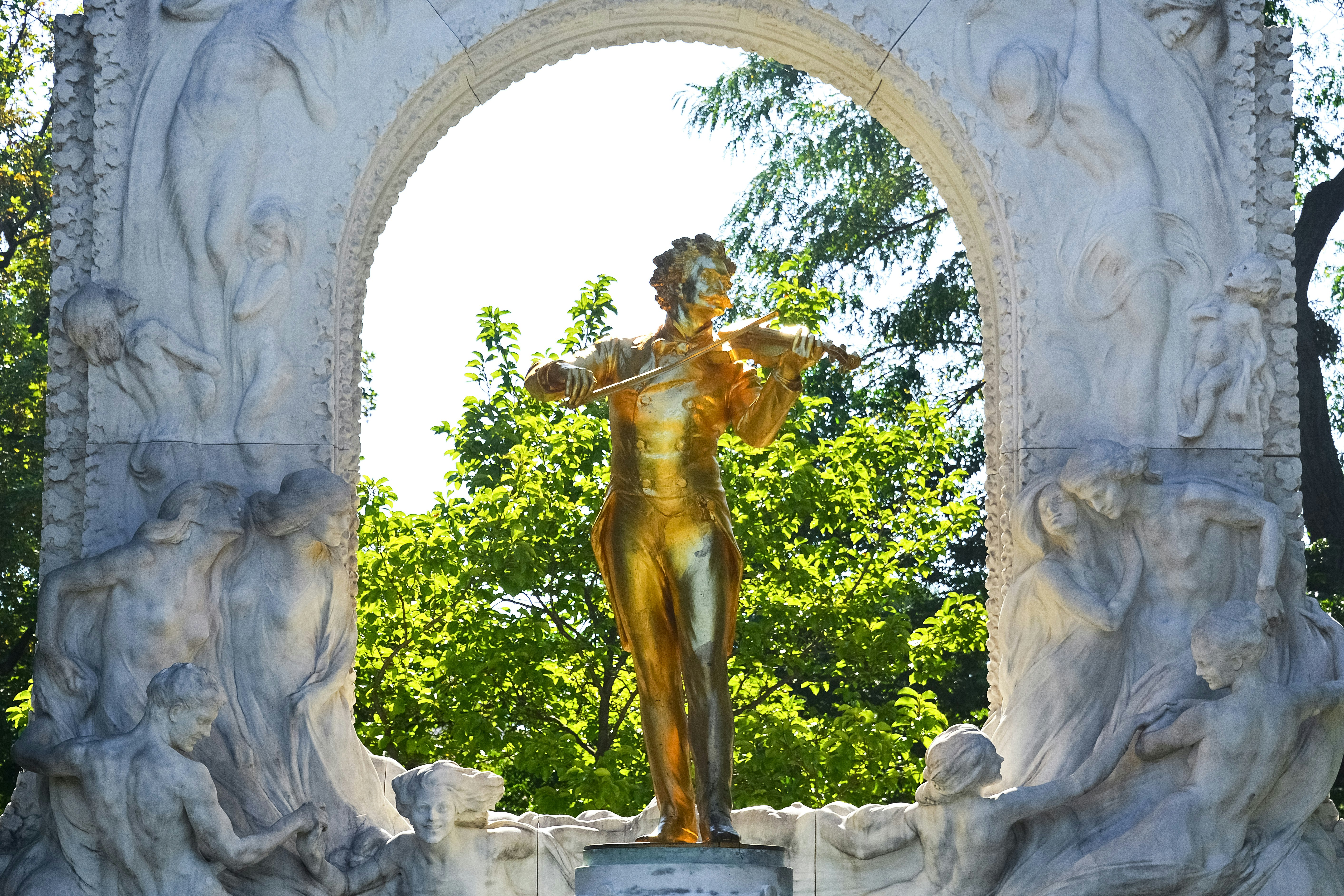 gold statue of man holding a baby